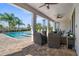 An open-air patio complete with brick-paver flooring, ceiling fans, and comfortable seating for entertaining guests outdoors at 7702 Fairfax Dr, Kissimmee, FL 34747