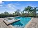 Sparkling pool and spa surrounded by palm trees and landscaped yard at 7702 Fairfax Dr, Kissimmee, FL 34747