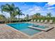 Sparkling swimming pool and spa surrounded by lush landscaping and lounge chairs, perfect for relaxation and entertainment at 7702 Fairfax Dr, Kissimmee, FL 34747