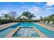 Relaxing pool and spa with lush landscaping and lounge chairs at 7702 Fairfax Dr, Kissimmee, FL 34747