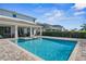 Beautiful backyard pool and spa area with lush landscaping at 7702 Fairfax Dr, Kissimmee, FL 34747
