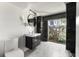 Contemporary bathroom features marble floors, sleek vanity, and a glass window view to stone accent wall at 812 2Nd St, Altamonte Springs, FL 32701