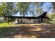 Contemporary home featuring a covered carport, stone fireplace, and expansive windows offering ample natural light at 812 2Nd St, Altamonte Springs, FL 32701