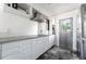 Modern kitchen with white cabinetry, sleek countertops, stainless steel appliances, and gray tile flooring at 812 2Nd St, Altamonte Springs, FL 32701