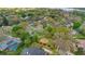 Scenic aerial view of a community park surrounded by homes with lush greenery and mature trees at 827 Royalwood Ln, Oviedo, FL 32765
