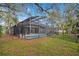 Spacious backyard featuring a screened pool, patio, and lush greenery at 827 Royalwood Ln, Oviedo, FL 32765