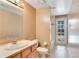 Bathroom features a single vanity, toilet, and access door to the pool area at 827 Royalwood Ln, Oviedo, FL 32765