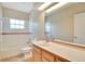 Bathroom featuring a tub with shower, a toilet, and a vanity with a large mirror at 827 Royalwood Ln, Oviedo, FL 32765