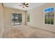 Large carpeted bedroom with sliding glass door to a screened lanai and pool view at 827 Royalwood Ln, Oviedo, FL 32765