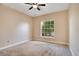 Bright bedroom with a ceiling fan, carpeted floor, and a large window at 827 Royalwood Ln, Oviedo, FL 32765