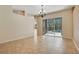 Open dining area with tile flooring and sliding doors leading to a screened patio at 827 Royalwood Ln, Oviedo, FL 32765