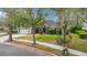 Charming single-Gathering home with a well-manicured front yard, large trees, and a two-car garage at 827 Royalwood Ln, Oviedo, FL 32765
