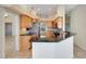 Modern kitchen with a stainless steel refrigerator and breakfast bar with granite countertops at 827 Royalwood Ln, Oviedo, FL 32765