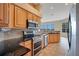 Gourmet kitchen with granite countertops, stainless steel appliances, and tile backsplash at 827 Royalwood Ln, Oviedo, FL 32765