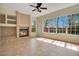 Bright living room with a fireplace and an abundance of natural light from the many windows at 827 Royalwood Ln, Oviedo, FL 32765