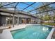 View of the screened pool, patio, and back exterior of home at 827 Royalwood Ln, Oviedo, FL 32765