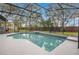 Screened pool with spa, concrete deck, and view of the backyard at 827 Royalwood Ln, Oviedo, FL 32765