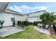 Well-manicured backyard with a stone patio and cozy outdoor seating area at 932 Kylee Aly, Winter Garden, FL 34787