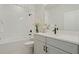 Well-lit bathroom featuring a tub-shower combo with black fixtures and a white vanity at 932 Kylee Aly, Winter Garden, FL 34787