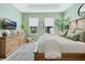 This bedroom is a comfortable retreat with a wood headboard, plush pillows, and natural light from large windows at 932 Kylee Aly, Winter Garden, FL 34787