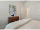 This well-lit bedroom features coastal art, a soft comforter, and a hallway view, creating a soothing retreat at 932 Kylee Aly, Winter Garden, FL 34787