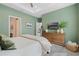 Bright bedroom features a ceiling fan, recessed lights, mounted TV, and wood dresser with decorative vases at 932 Kylee Aly, Winter Garden, FL 34787