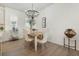 Dining room includes a modern chandelier and seating for four at 932 Kylee Aly, Winter Garden, FL 34787