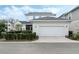 Two story home featuring an attached garage and well-maintained landscaping at 932 Kylee Aly, Winter Garden, FL 34787