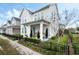 Charming two-story home with white siding, landscaped yard, and a welcoming front porch at 932 Kylee Aly, Winter Garden, FL 34787