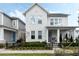 Attractive two-story home with a welcoming front porch, manicured landscaping, and a black metal fence at 932 Kylee Aly, Winter Garden, FL 34787