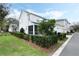 Charming home with a manicured lawn, including a view of the screened-in porch at 932 Kylee Aly, Winter Garden, FL 34787