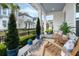 Comfortable front porch with rocking chairs, greenery, and a stylish outdoor rug at 932 Kylee Aly, Winter Garden, FL 34787