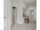 Spacious hallway with neutral carpet and white walls, leading to various rooms at 932 Kylee Aly, Winter Garden, FL 34787