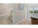 Hallway leading to bathroom and bedroom with carpeted floors and natural light at 932 Kylee Aly, Winter Garden, FL 34787