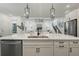Open kitchen featuring a large island and undermount sink, seamlessly flowing into the living area at 932 Kylee Aly, Winter Garden, FL 34787