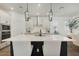 Bright kitchen with a large center island and seating for two, pendant lighting and stainless appliances at 932 Kylee Aly, Winter Garden, FL 34787