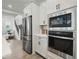 Kitchen features stainless steel appliances, built in oven and microwave, and view into living space at 932 Kylee Aly, Winter Garden, FL 34787