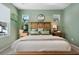 Cozy main bedroom with light green walls, natural light, and stylish decor at 932 Kylee Aly, Winter Garden, FL 34787