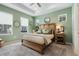 Serene main bedroom with light green walls, natural light, and stylish decor at 932 Kylee Aly, Winter Garden, FL 34787