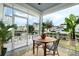 Screened patio featuring a charming table with chairs and inviting outdoor ambiance at 932 Kylee Aly, Winter Garden, FL 34787