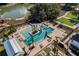 Stunning pool area with palm trees and lounge chairs, perfect for relaxation and entertainment by the lake at 932 Kylee Aly, Winter Garden, FL 34787
