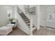 Elegant staircase with carpeted steps, black metal railings, and decorative wall art at 932 Kylee Aly, Winter Garden, FL 34787