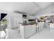 Bright kitchen with island, breakfast bar, and white tile floors at 1022 Antelope Trl, Winter Springs, FL 32708