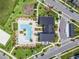 An aerial view of community pool, amenity center, and surrounding landscaping including parking and sidewalks at 10267 Authors Way, Orlando, FL 32832