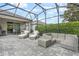 Covered screened-in patio showcasing stylish outdoor furniture perfect for relaxing or entertaining guests at 10267 Authors Way, Orlando, FL 32832