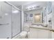 Well-lit bathroom featuring a shower-tub combo, a large mirror and a sink with white cabinets at 1027 Park Ridge Cir, Kissimmee, FL 34746