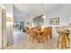 Open-concept dining area with tile flooring and a view to the kitchen and living room at 1027 Park Ridge Cir, Kissimmee, FL 34746