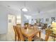 Open-concept dining room with a view to the living room and a table for six at 1027 Park Ridge Cir, Kissimmee, FL 34746