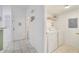 Convenient laundry room with modern washer and dryer, storage shelves, and tile flooring at 1027 Park Ridge Cir, Kissimmee, FL 34746