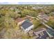Aerial view of a white two-story house, featuring a pool and large green backyard at 1063 Eagles Forrest, Apopka, FL 32712